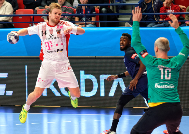 Eine Gruppe von Männern, die auf einem Feld Handball spielen, während eines Spiels zwischen Bayern München und Paris Saint-Germain bei der Futsal-Weltmeisterschaft 2019, mit Zuschauern im Hintergrund.