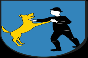Mann mit Hut, der einen Hund hält, der auf seinen Hinterbeinen vor dem Stadtwappen von Stuttgart auf einem Schild steht.